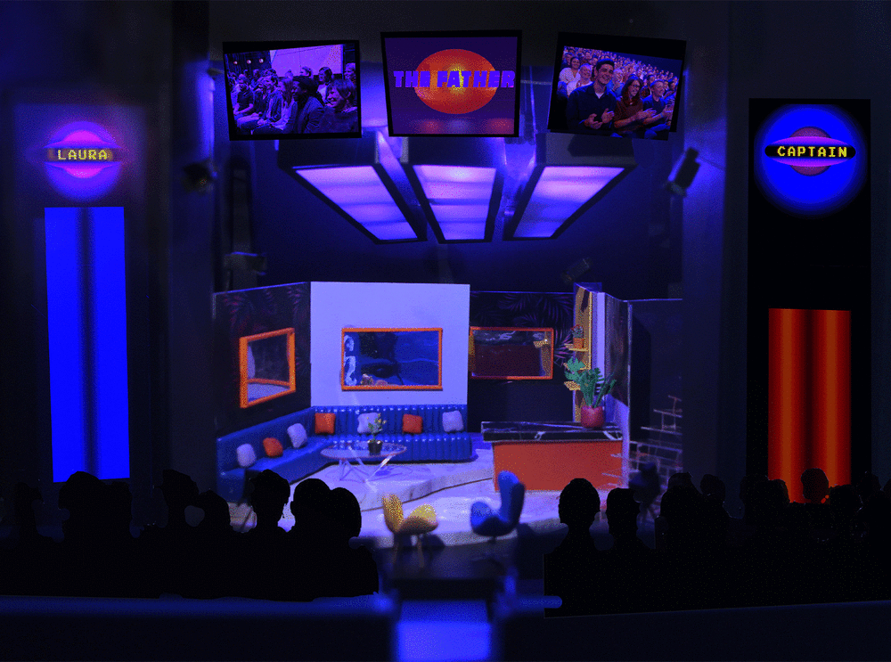 Model set of scene in the play with audience looking at stage