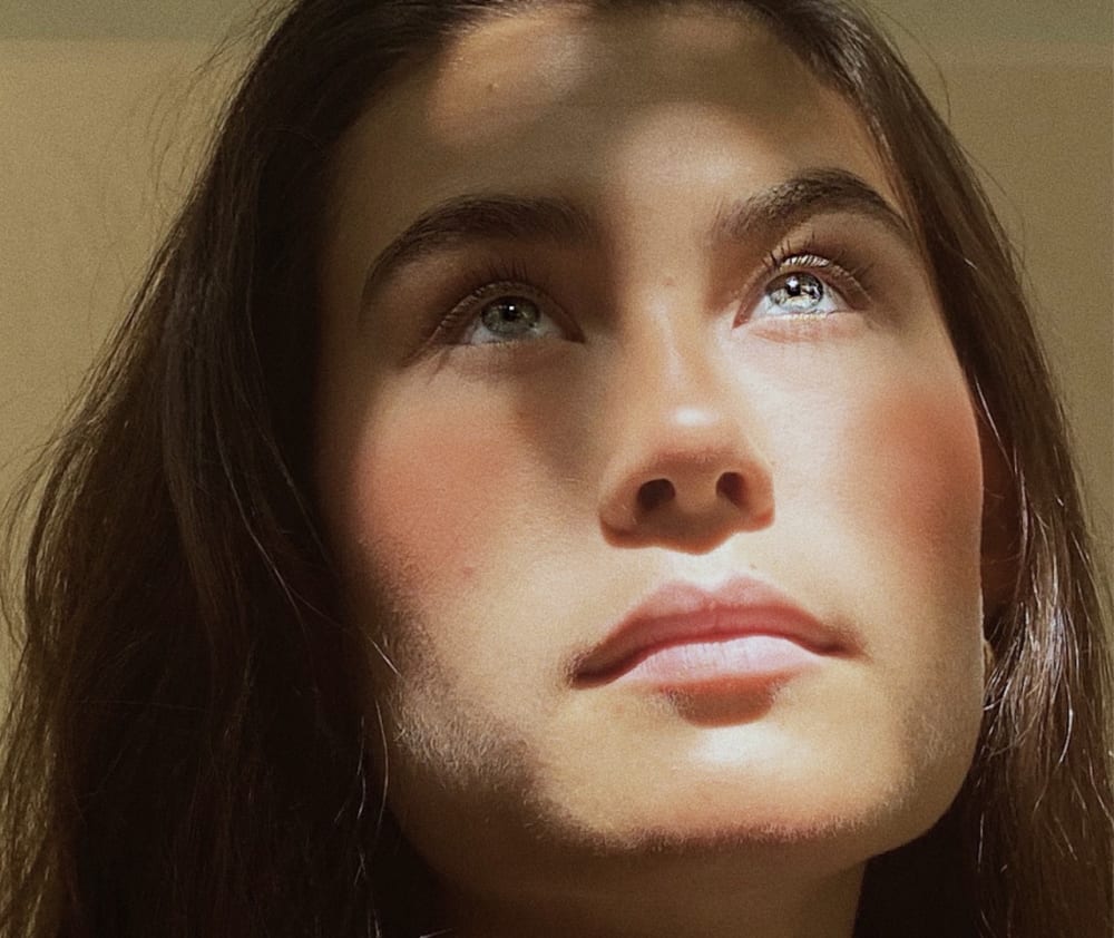 A close-up portrait of a woman.