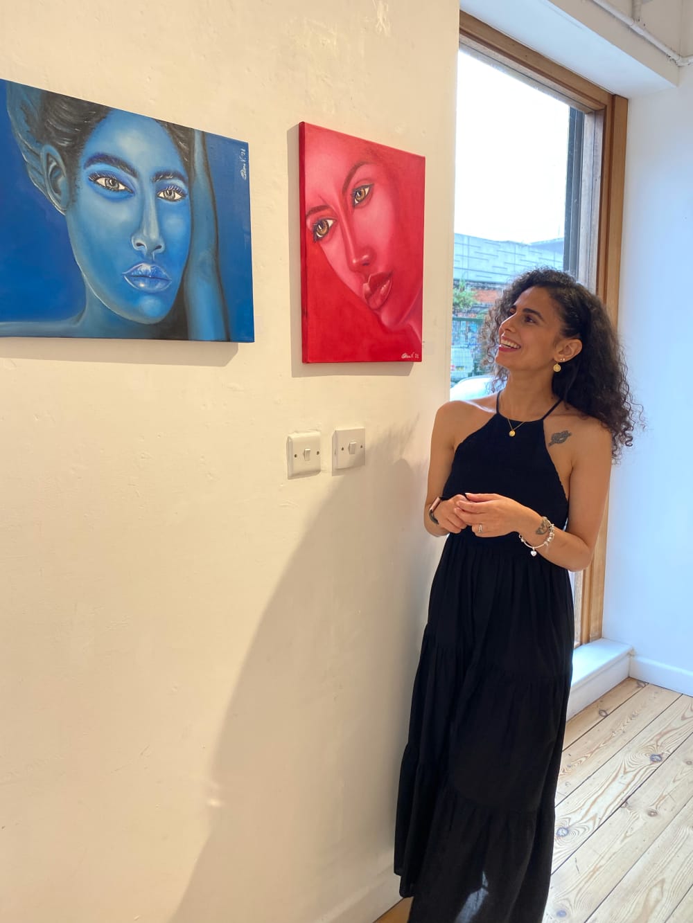 Photo of Chiara next to 2 of her pieces