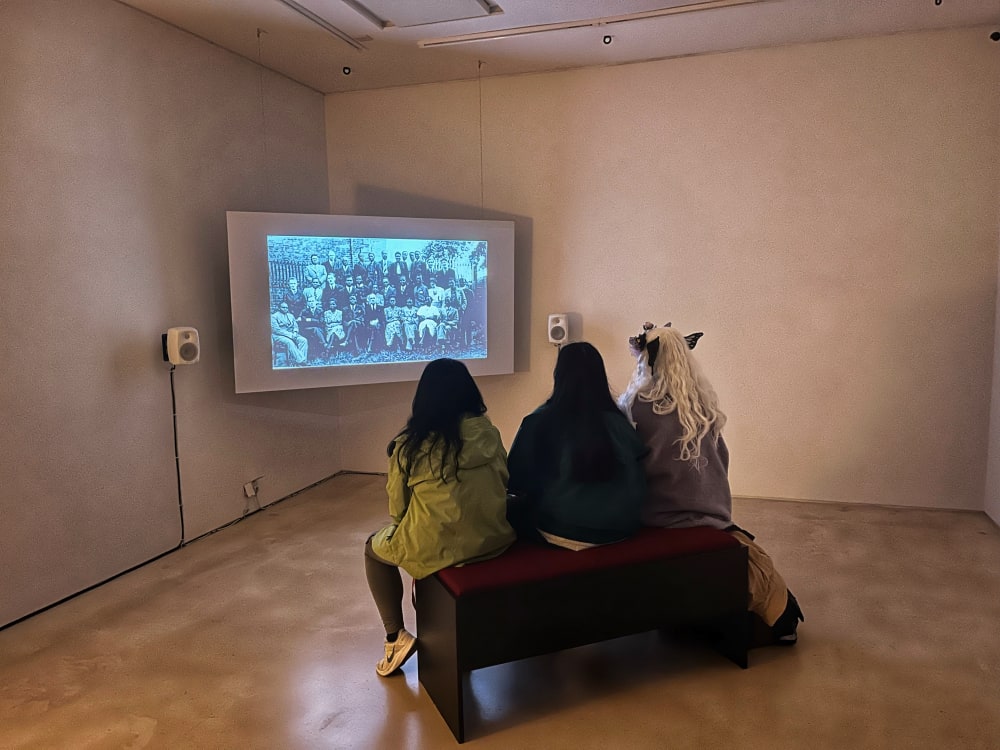 three people watching a film