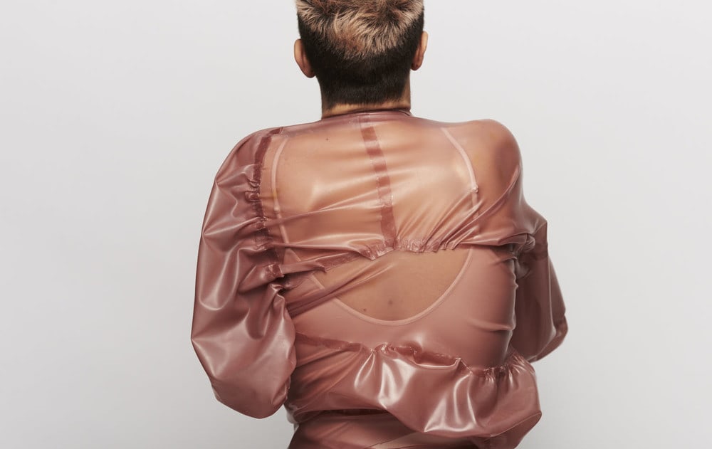 Model wearing pink latex jacket