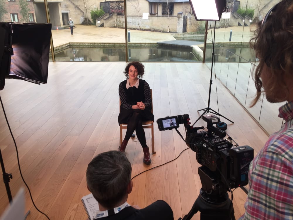 Photograph of seated woman (Elisabeth) being filmed by cameras