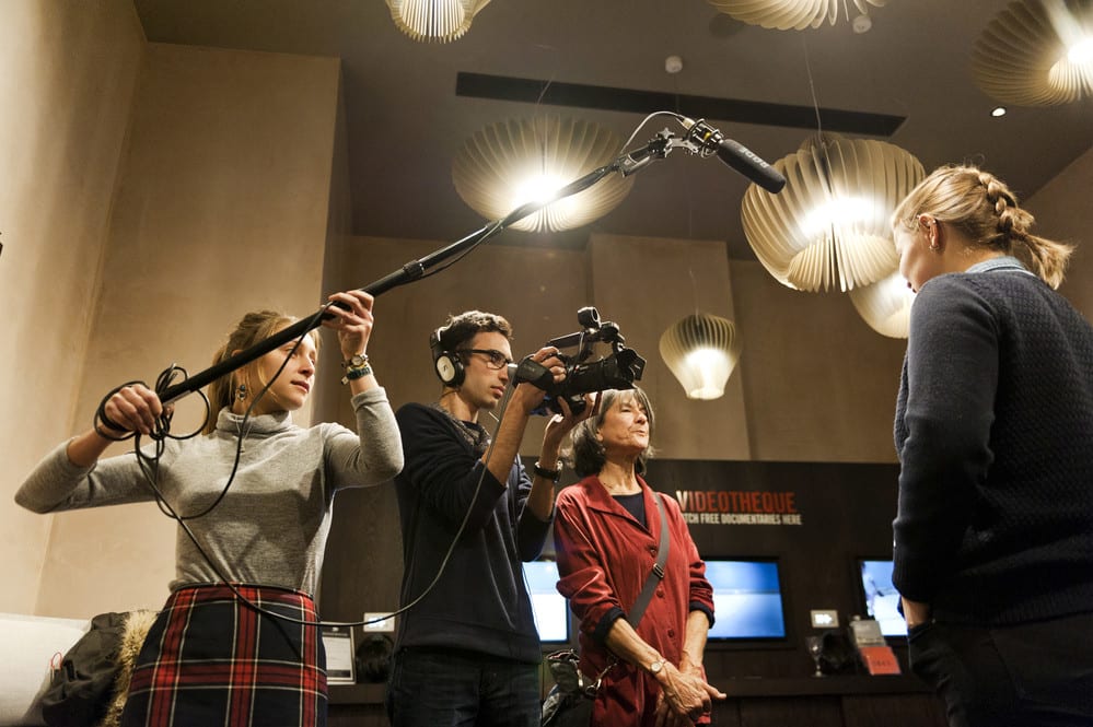 Students holding camera and microphone during interview