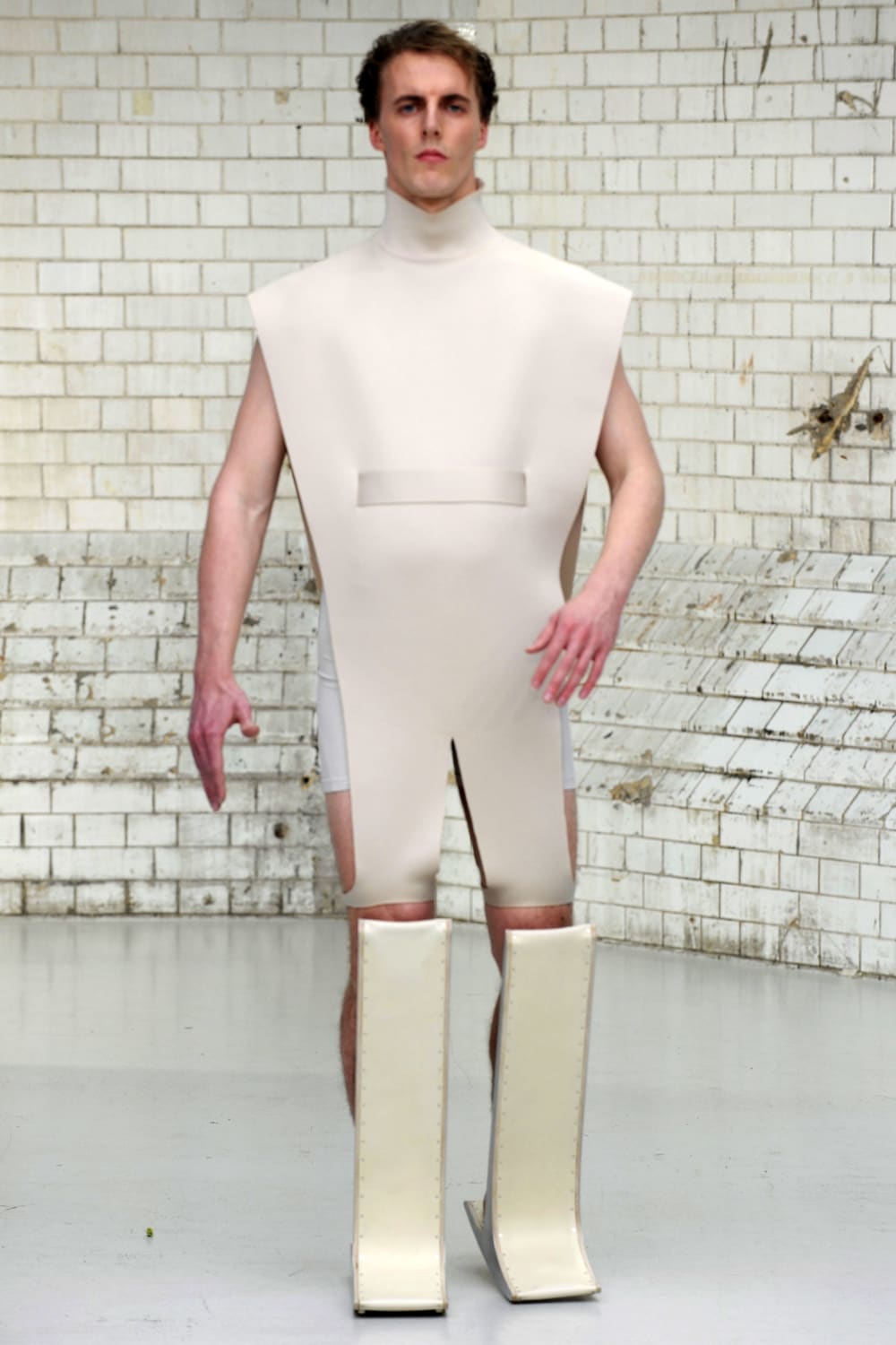 Model wearing wooden footwear on catwalk