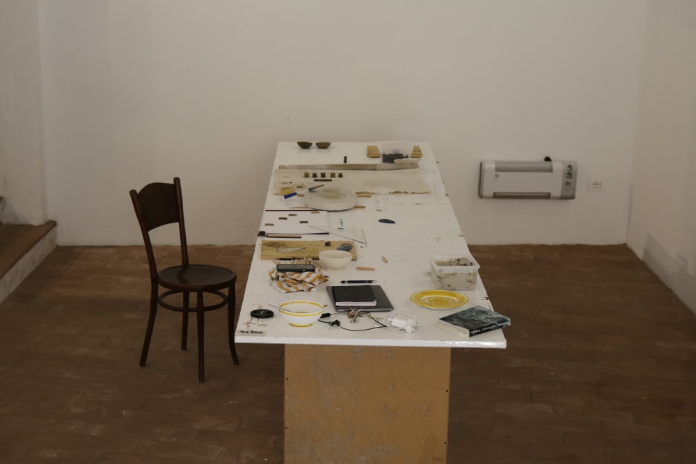 a table with papers and clay