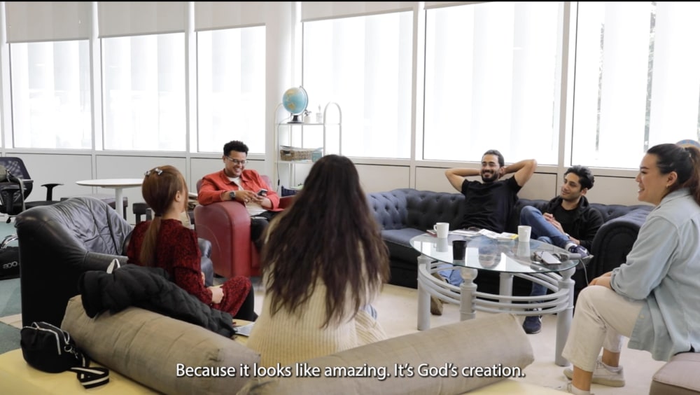 People sat around a table chatting