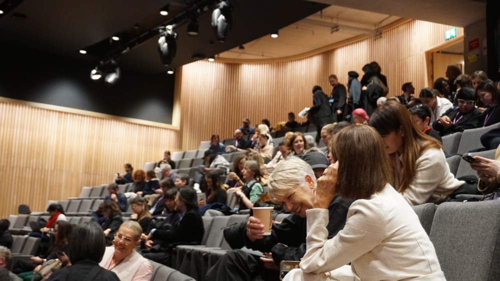 People sat in a lecture theatre.