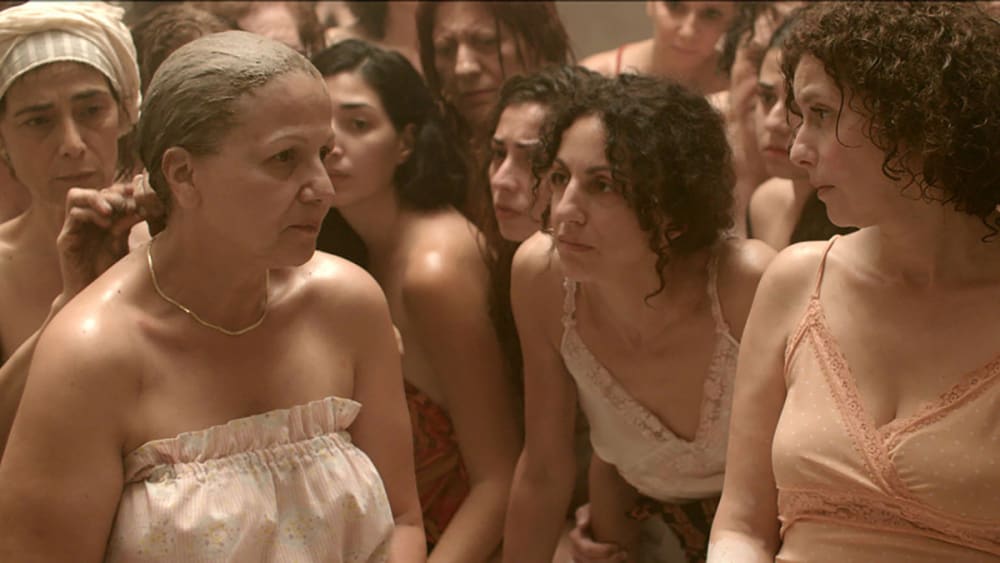 A film still of women in a public bath.