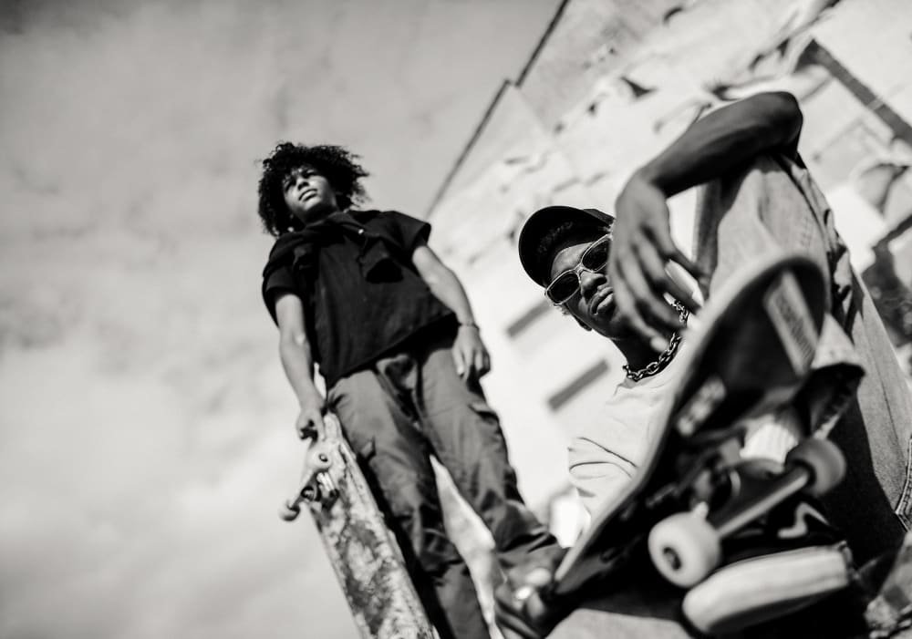 Two guys at a skate park with glasses on