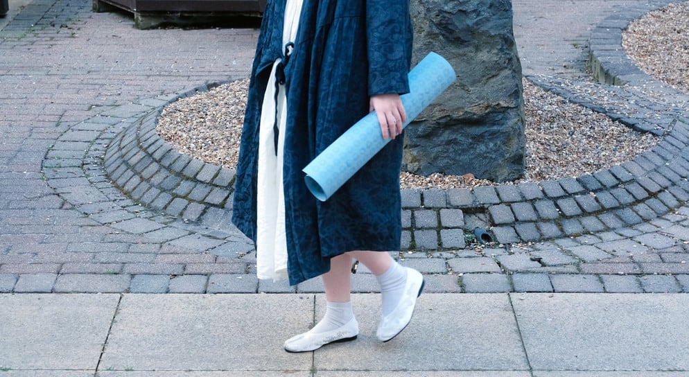 Image of a girl walking with a scroll in her hand