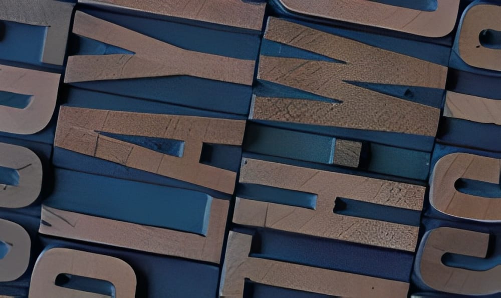 The book cover of Cathy Lane’s ‘Playing with Words’. It features a close-up image of print blocks spelling out the title.