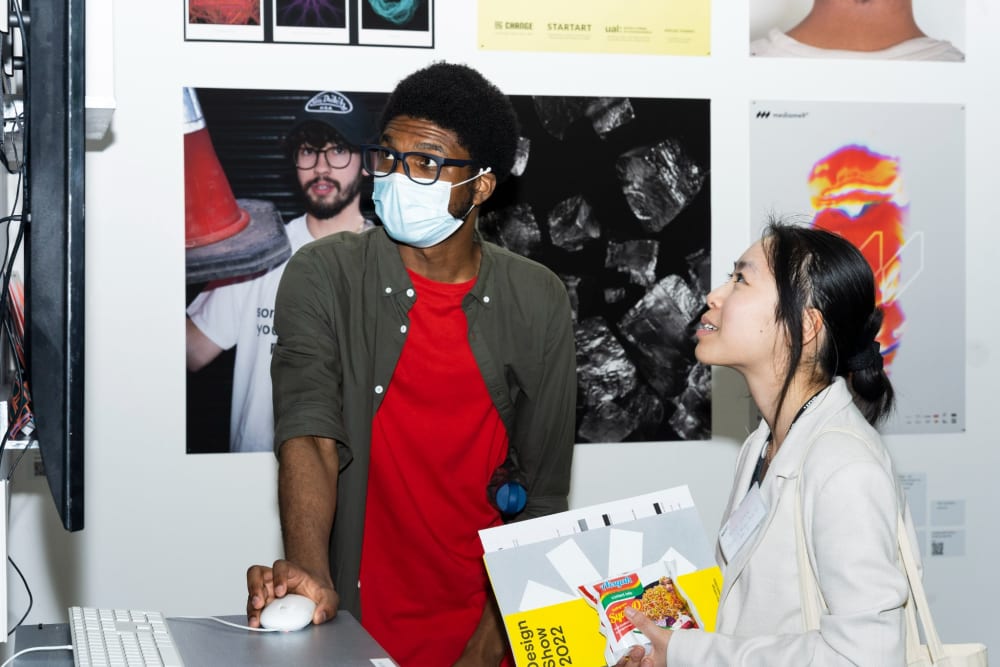 Guest being shown work by a student