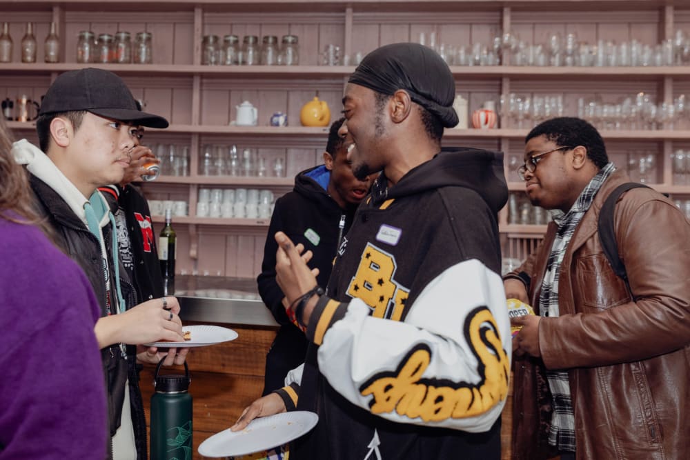 Two young men talking at an event.