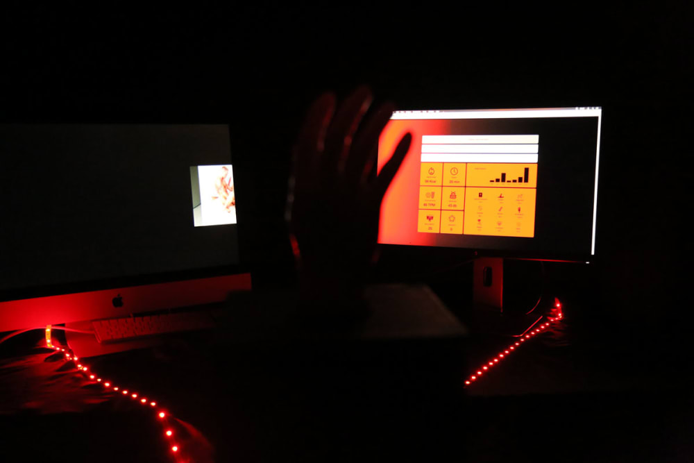 hand and two screens with charts