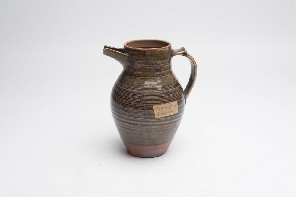 Side view of water jug, ceramic with brown/green glaze