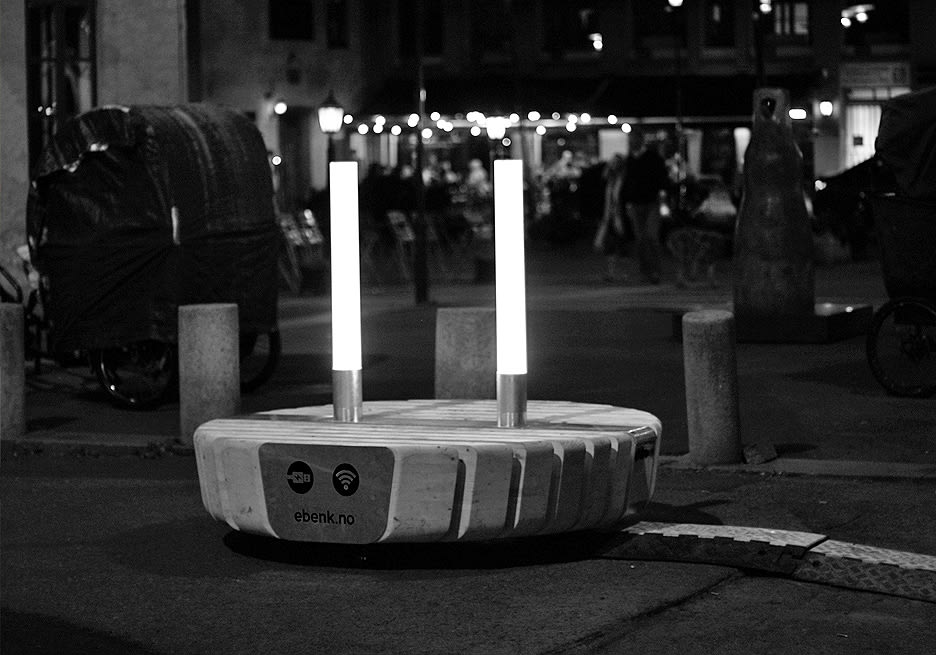 A round concrete bench with two lights sticking out of the top