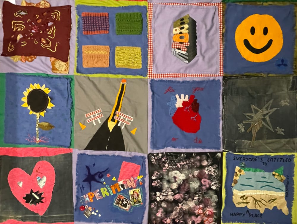 A patchwork quilt with individuals artwork on the front and polaroids of the artists on the back.