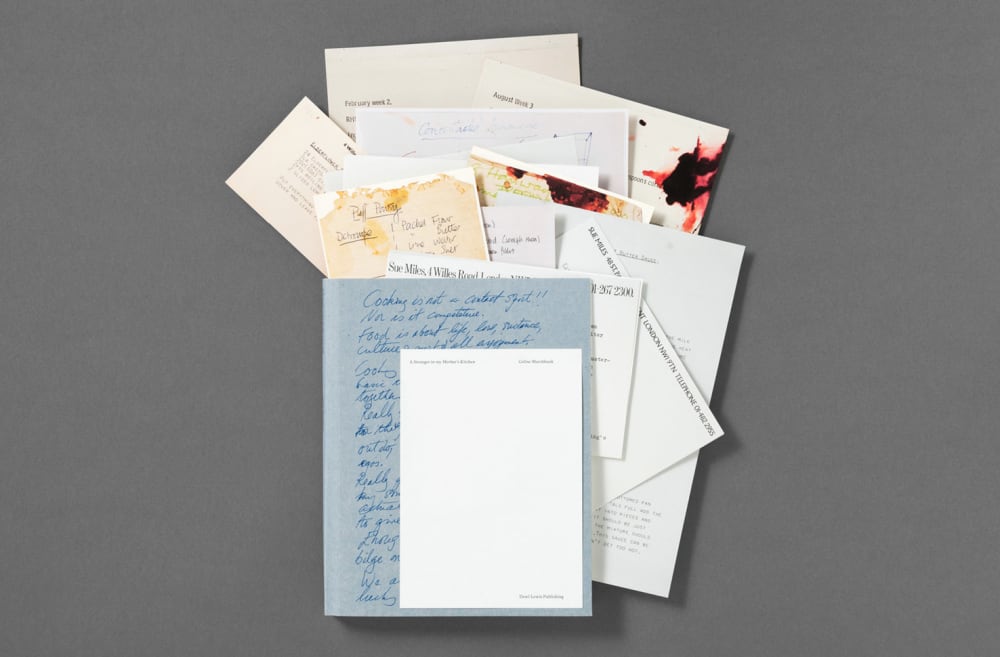 a notebook with images and recipes spilling out of it
