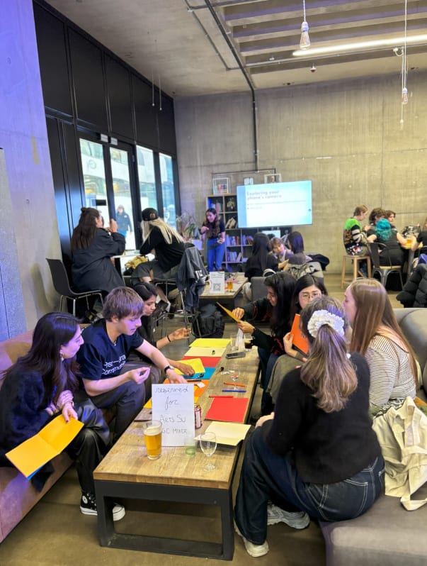 Students seating at a table and talking