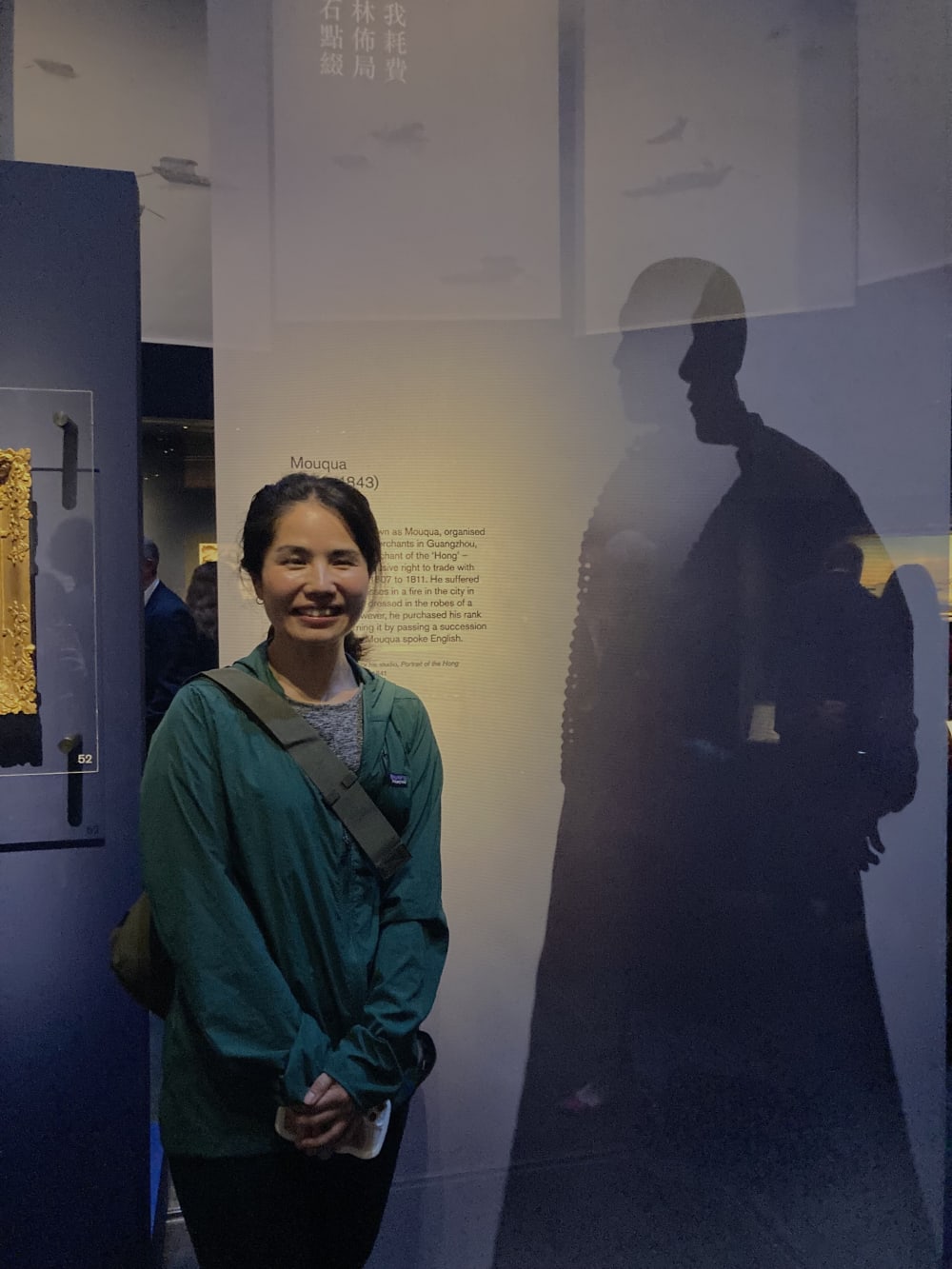 Person smiling and standing by China's Hidden Century display