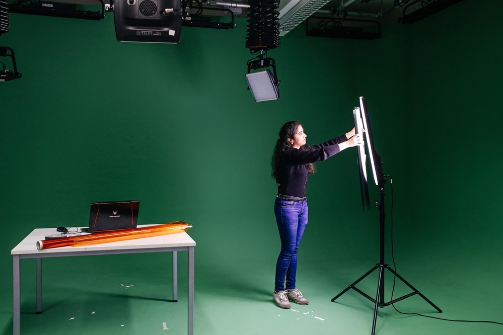 Student with green screen