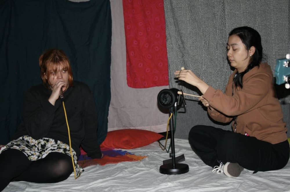 Two people speaking into microphones