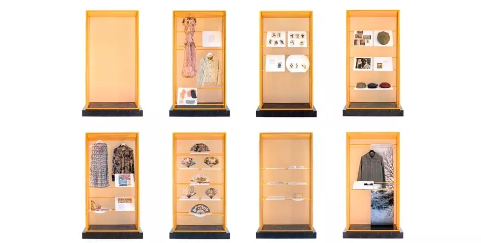 Two rows of yellow cabinets, four in each row, each displaying objects.