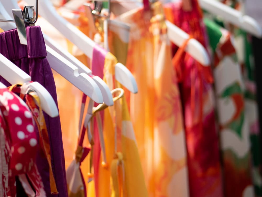 Close up of colourful clothing on a rail
