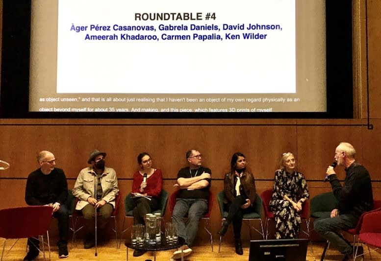 Group of people sitting as a panel at an event