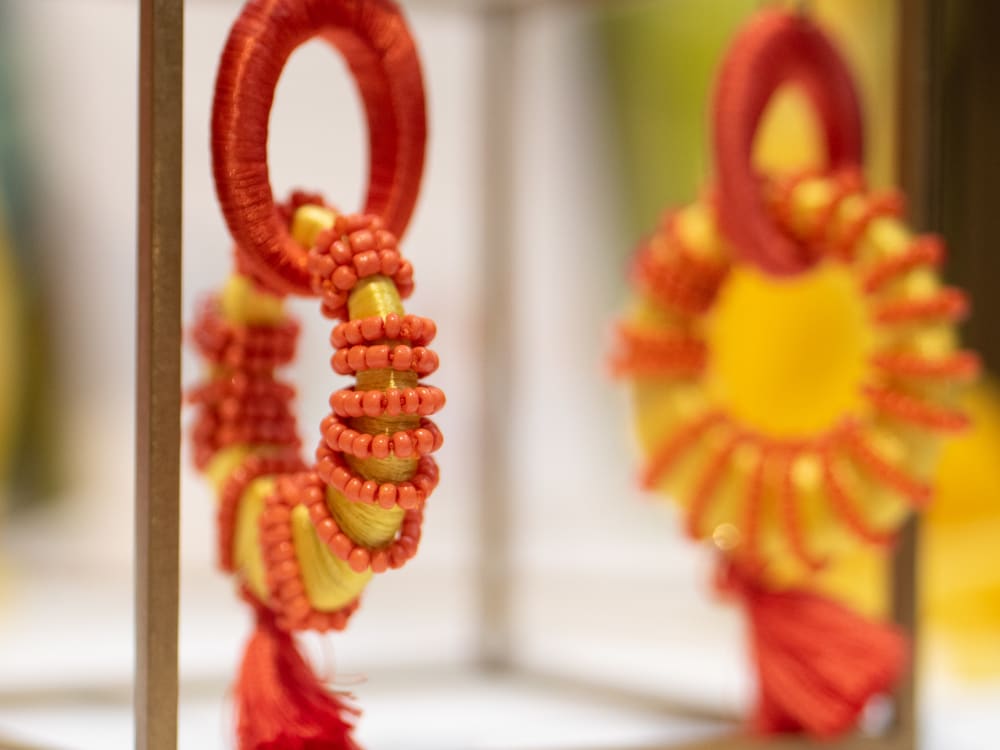 Orange earrings on a jewellery holder