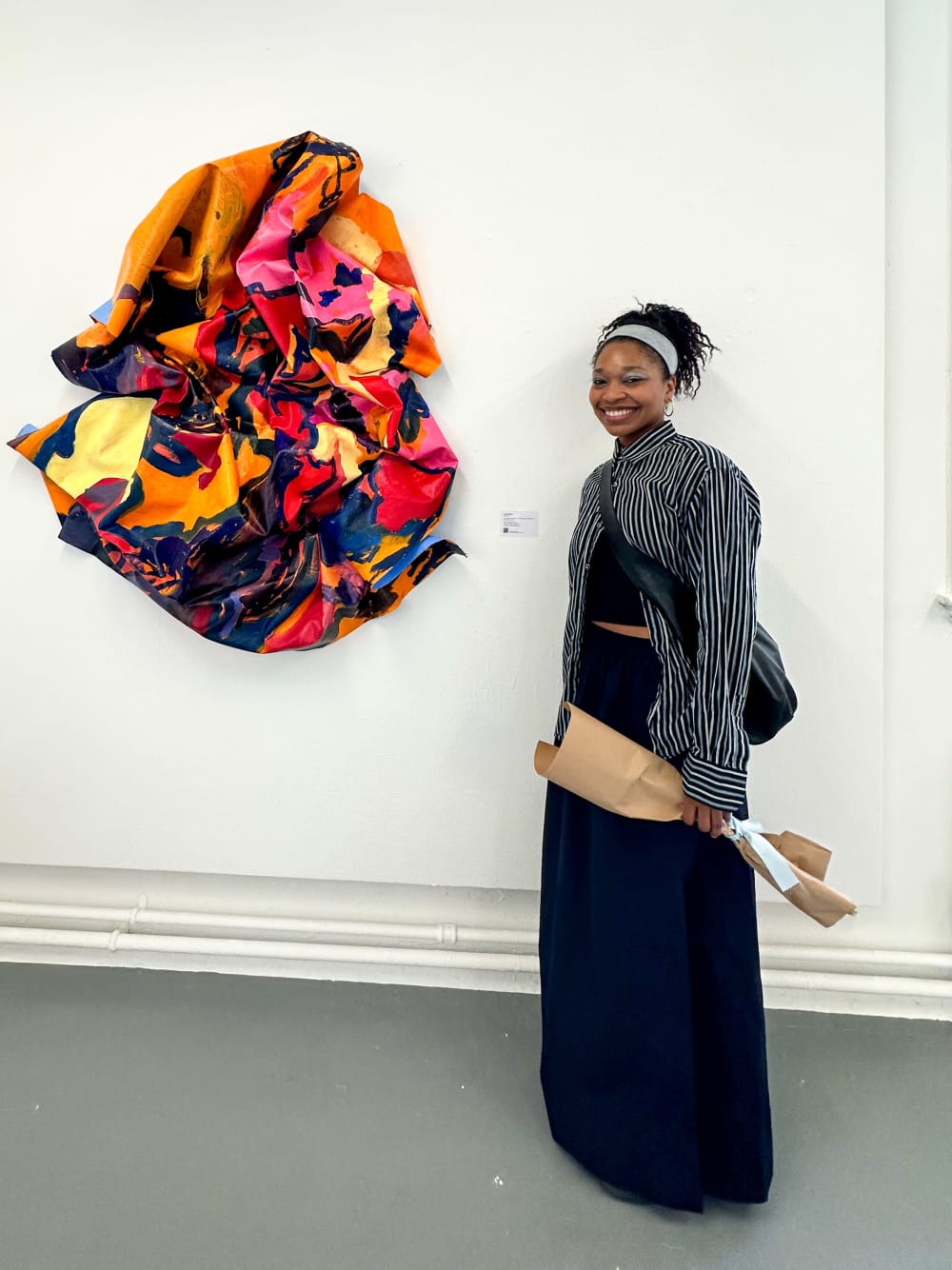 the artist Lola Collins stood in front of her artwork