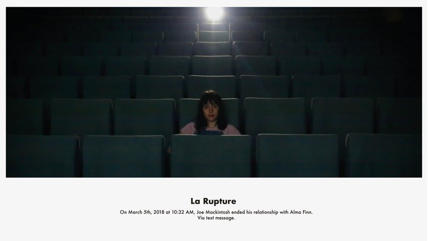 a woman sitting in a cinema alone