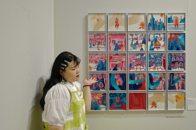 Meinchen Lu in fron of her work