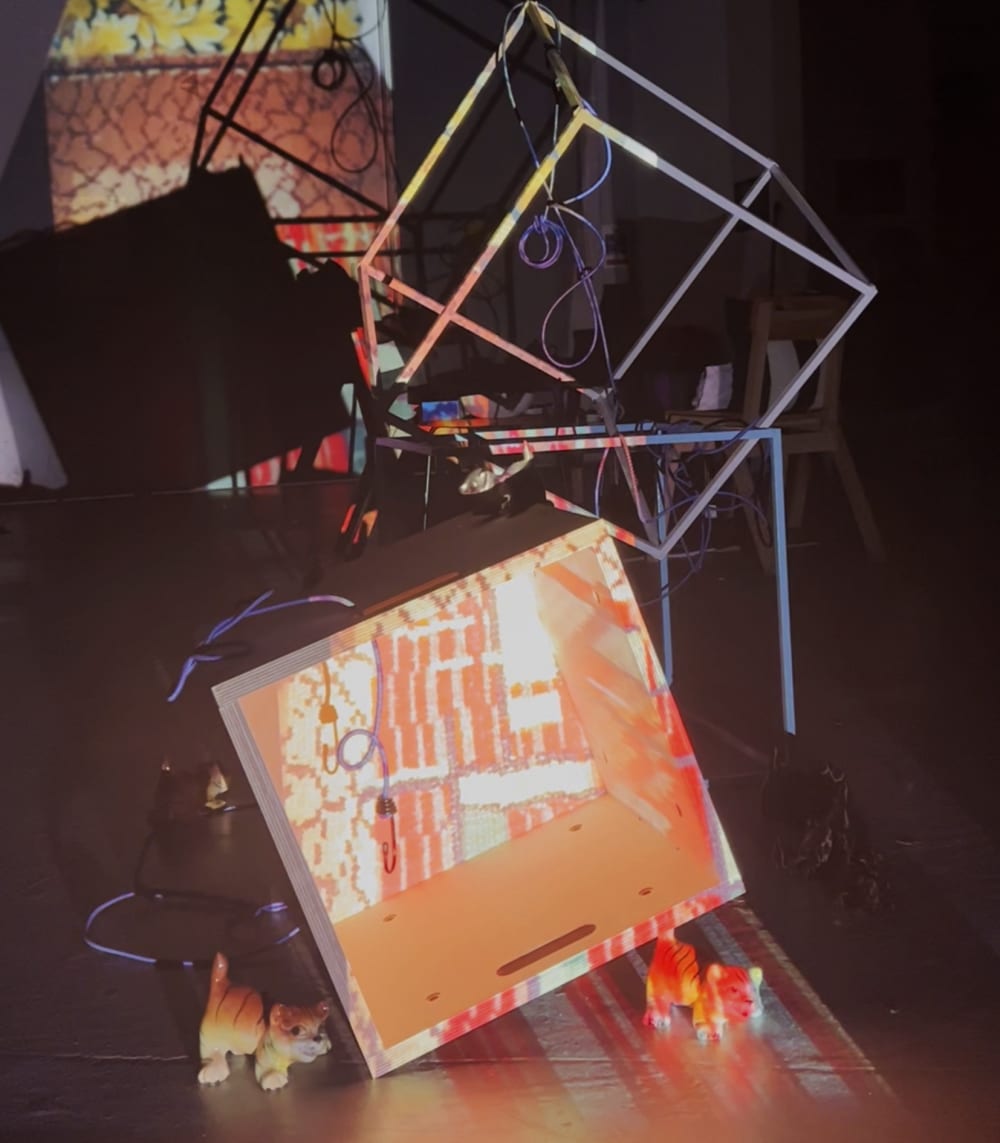 Art installation using metal and wires. On the floor are tiger figurers