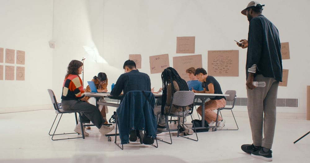 Group of people working together in a large white space