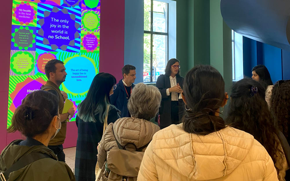 Group of people listening to a curator talk