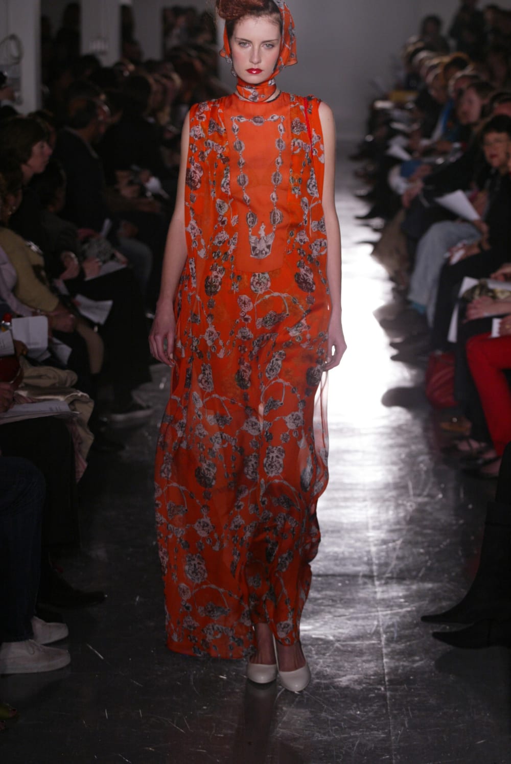 Fashion model wearing a red dress on a catwalk