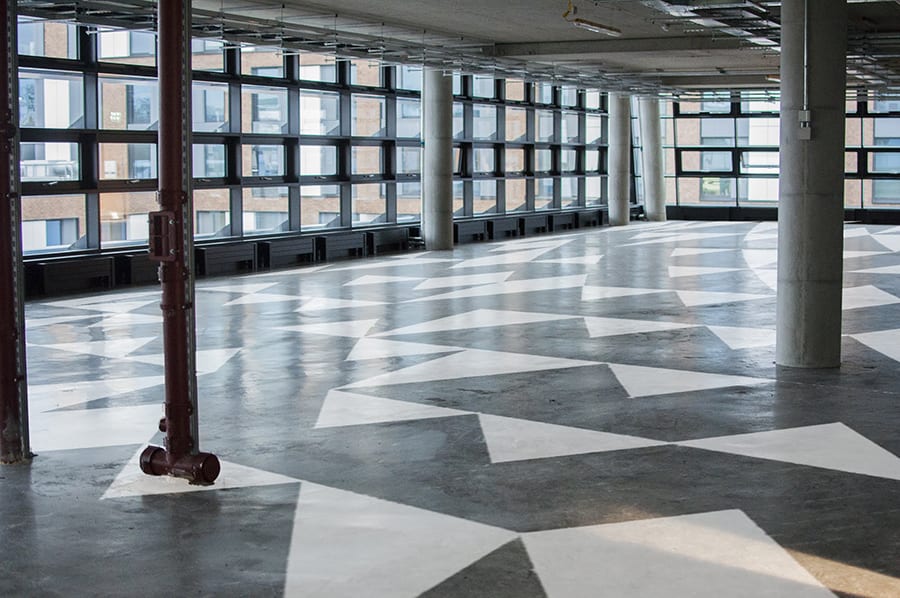 An interior of a building with a black and white triangle pattern on the floor.