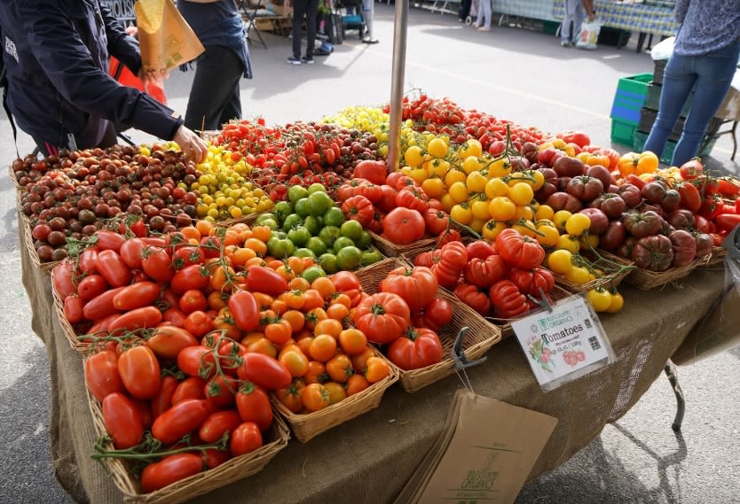 A fruit and vegetable stall at a farmers market.