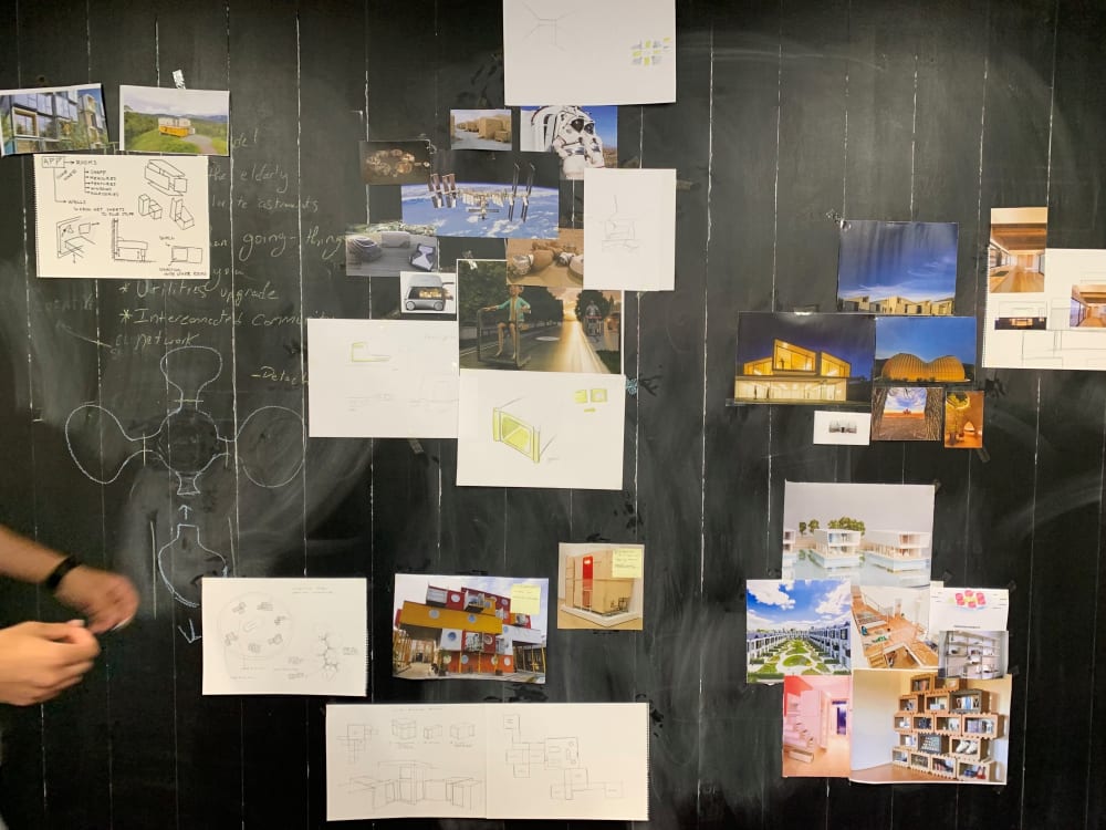 A blackboard with images of space and architecture