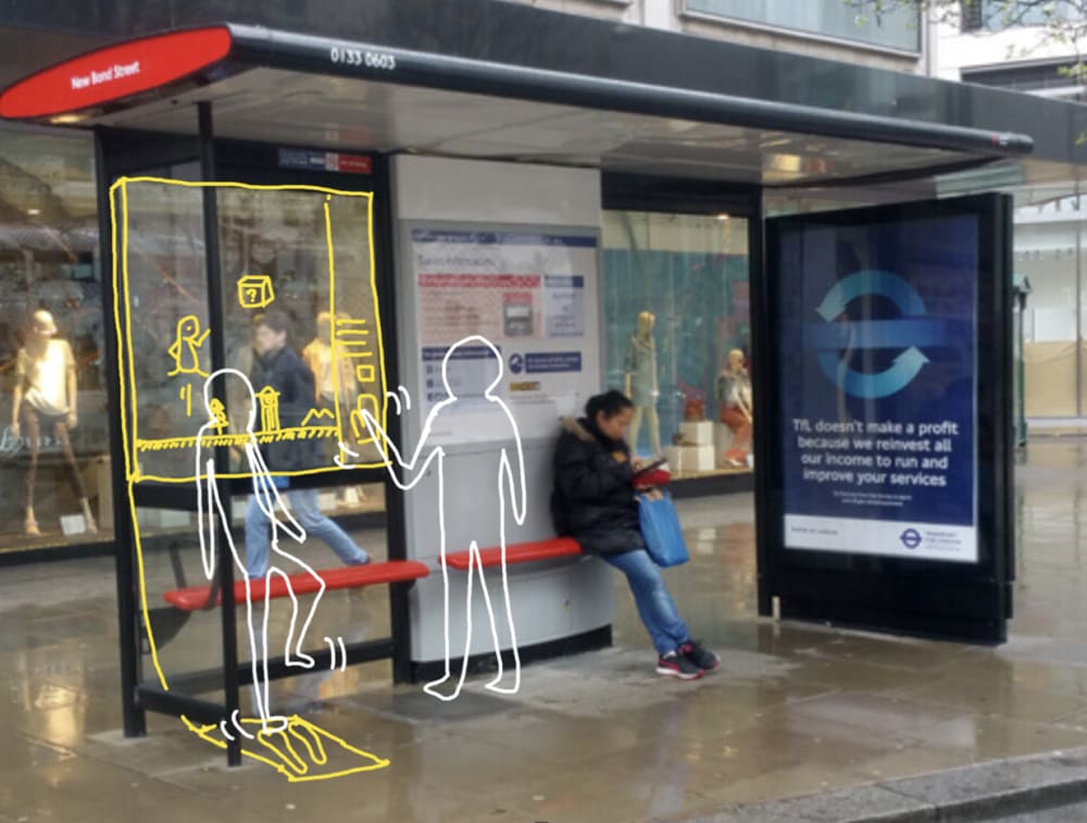 photo of a bus stop with illustrated stick figures standing next to it