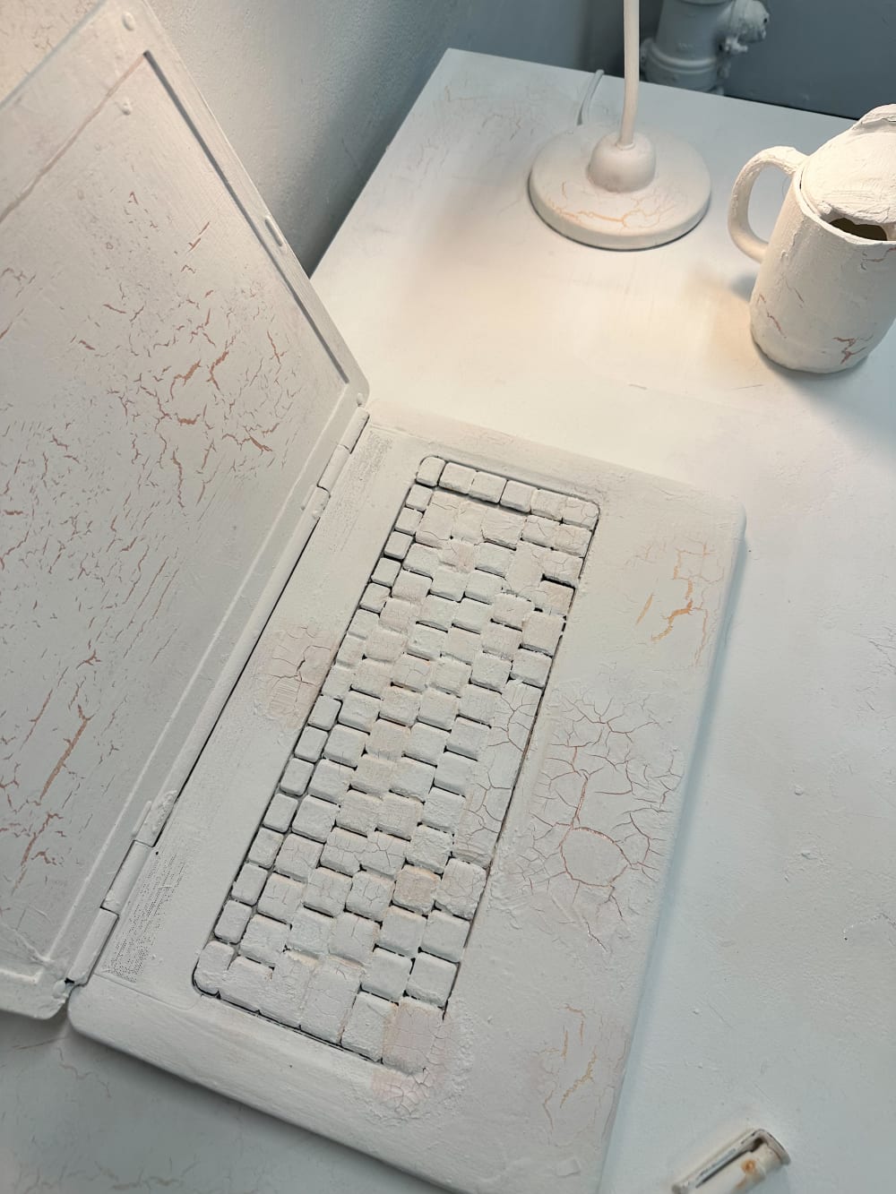 a laptop covered in white paint