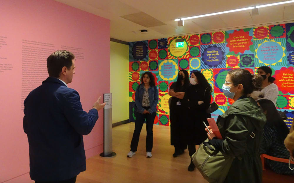 Group of people listening to a curator talk