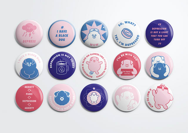 Three rows of badges with different slogans and images on.