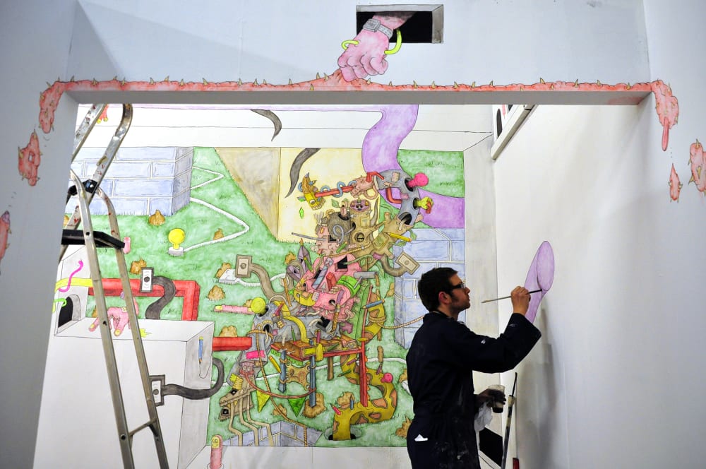Paul Westcombe painting in the gallery.