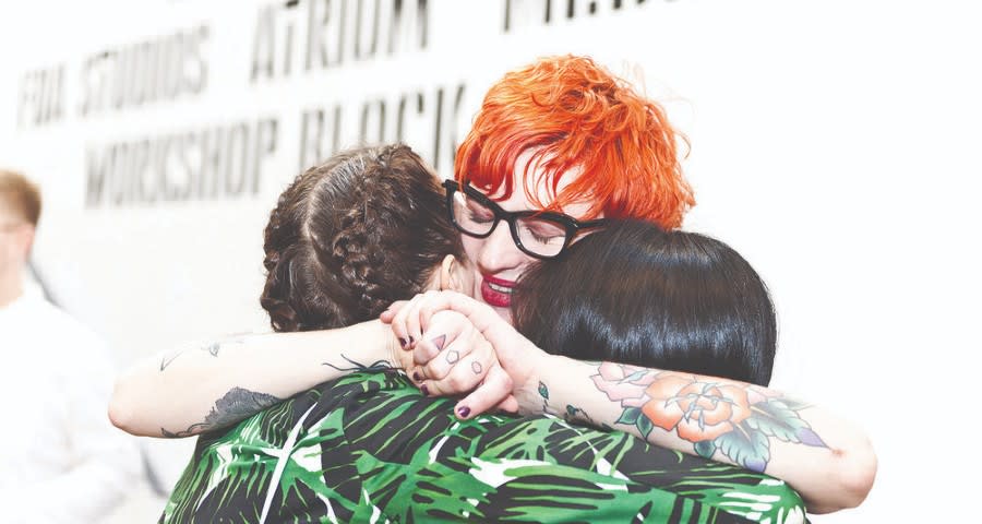 People hugging each other and smiling.