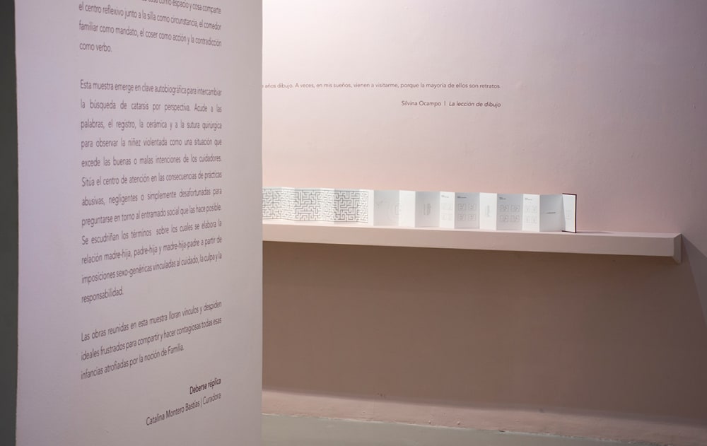 A long, concertina-shaped book on display at an exhibition.
