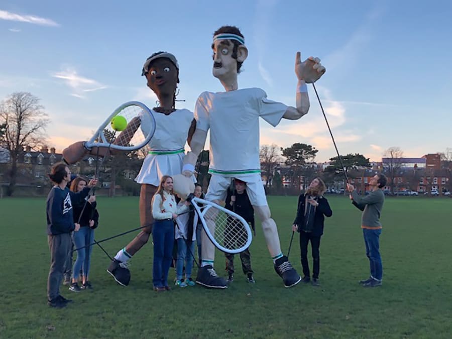 Students with giant puppets of tennis players in Dundonal recreation ground.