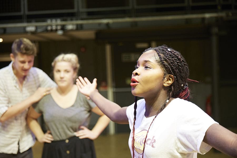 A woman on a stage talking.