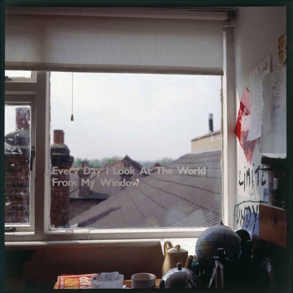 a photo of a window with a decal that reads 'every day i look at the world from my window'